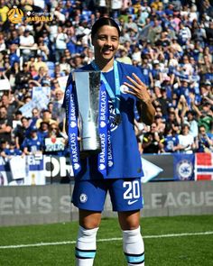 the soccer player is holding up his trophy