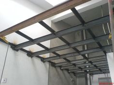 the inside of a building that is being constructed with metal beams and steel studs