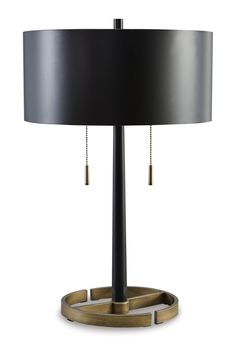 a table lamp with a black shade and gold trimmings on the bottom half