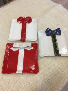 three plates with bows on them sitting on a table