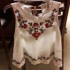 This Max Studio Top Is Beautiful. White With Pretty Flower Design. Tie Neck In Back. Cute White Sleeveless Blouse, Cute White Blouse With Floral Print, Cute White Blouse With Floral Embroidery, Cute Red Tops With Floral Embroidery, Red Floral Embroidered Peasant Top, Red Bohemian Embroidered V-neck Top, Pretty Flower, Max Studio, Tie Neck