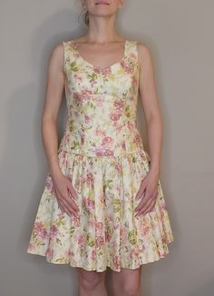 1990s sleeveless Laura Ashley floral pattern dress. Marked as size 8, but fits a modern size 4 (model in photos measurements are 34"-27"-37"). Pre-owned. Zip back closure with slightly dropped waist. One layer petticoat underneath skirt. Length from shoulder to hem: 33.5", Bust: 34", Waist: 28". Fitted Sleeveless Floral Sundress, Spring Sleeveless Fitted Bodice Dress, Sleeveless Lined Floral Sundress, Lined Sleeveless Floral Sundress, Fitted Sleeveless Floral Print Dress, Floral Print Fit And Flare Sleeveless Dress, Sleeveless Floral Dress With Fitted Bodice, Fit And Flare Floral Print Sleeveless Dress, Sleeveless Floral Dress With Fitted Bodice For Garden Party