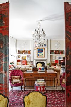 a living room filled with furniture and a chandelier