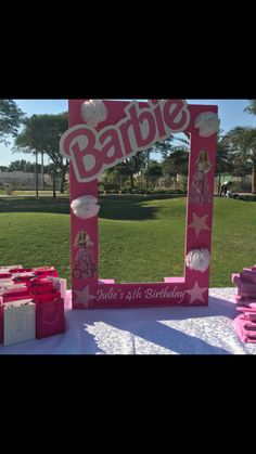 a table topped with pink boxes and a sign that says baby on it's side