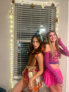 two girls dressed in costumes posing for the camera