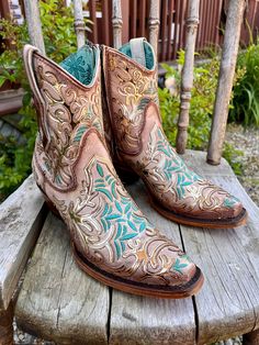 Delight in the beauty of these Corral Bone boots! A dazzling golden mirror-like overlay, stunning turquoise embroidery, and classic zipper add style and flair. With a 7 1/4" shaft and 2" heel, plus a snip toe, these boots will turn heads with every step! Antique white boot Gold mirror overlay Turquoise embroidery Zipper 7 1/4" Shaft 2" Heel Snip Toe Mirror Overlay, Ankle Cowgirl Boots, Turquoise Embroidery, Bone Boots, Golden Mirror, Western Store, Black Embroidery, Cowgirl Western, Store Hours