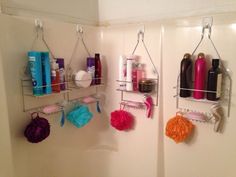 two shower shelves with hair products hanging on them