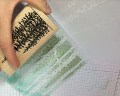 someone is using a rubber stamp to make their own tree design on the back of a piece of paper