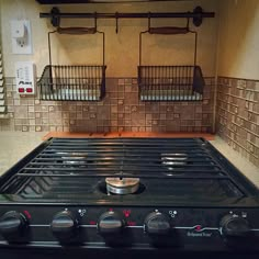 a black stove top oven sitting inside of a kitchen