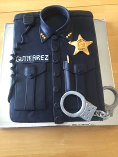 a cake that is shaped like a police officer's uniform with handcuffs on it