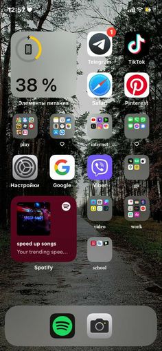 an iphone screen with various icons on it and trees in the backgrouund