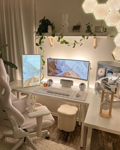 a computer desk with two monitors and a white chair