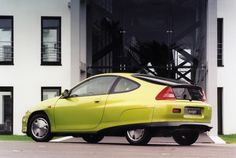 a yellow car parked in front of a building