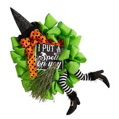 a green wreath with black and white striped stockings, witch's hat and polka dots