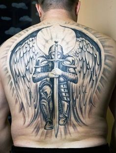 a man with a cross and wings tattoo on his back