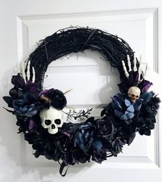 a wreath with skulls and flowers on it