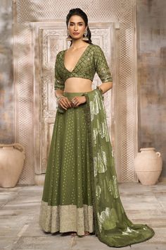 Olive green lehenga with golden petite patterns. Comes with sequin embroidered blouse and floral woven pattern frill bordered dupatta. - Aza Fashions Olive Green Lehenga Combination, Green Chanderi Lehenga With Unstitched Blouse, Green Designer Choli For Party Wear, Festive Pista Green Anarkali Set For Party, Green Georgette Lehenga With Gota Work, Party Wear Green Dupatta With Mirror Work, Green Anarkali Saree Set For Party Wear, Party Wear Choli With Cutdana For Festive Occasions, Party Wear Green Anarkali Set For Festive Occasions