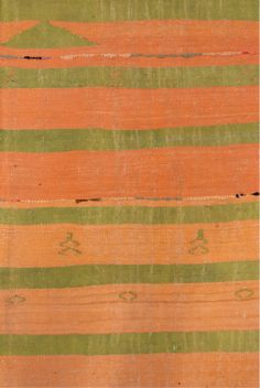 an orange and green striped rug with small designs on the bottom, in different colors