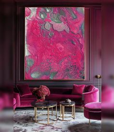 a living room filled with furniture and a large pink painting on the wall above it