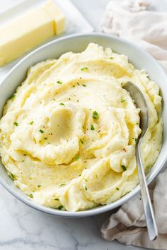 mashed potatoes in a white bowl with a spoon