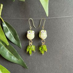 These bright green owls in their bed of green leaves will be a fun addition for any outfit. Spring Green Dangle Earrings, Green Dangle Earrings For Spring, Green Dangle Jewelry For Spring, Green Casual Earrings For Spring, Casual Green Earrings For Spring, Green Handmade Fun Earrings, Quirky Handmade Green Jewelry, Green Dangle Earrings With Fun Style, Playful Green Summer Jewelry