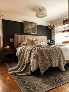 a bedroom with a bed, rugs and pictures on the wall above it's headboard