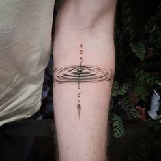 a man with a tattoo on his arm that has circles and lines in the middle