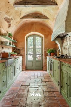 a kitchen with green cabinets and brick flooring