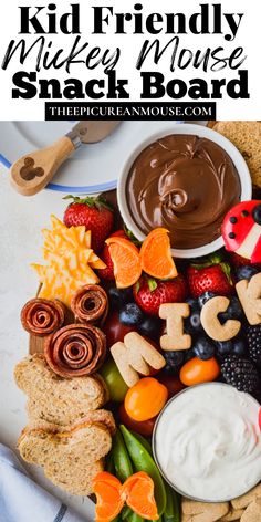 a platter filled with cheese, crackers, fruit and dip for kids to make