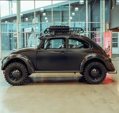 an old beetle car is parked in a building