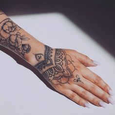 a woman's hand with a tattoo on it