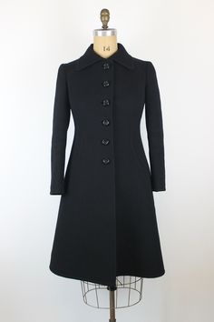 1960s Vintage EMILIO SCHUBERTH Black Wool Coat Brand: Emilio Schuberth Origin: Italy Fits like: EU M-L Measurements: Shoulder to Shoulder - 40cm/15,8" Bust - 100cm/39,4" Waist -88cm/34,6" Length - 102cm/40,2" Sleeve Length - 58,5cm/23" Displayed on the mannequin with the measurements: 99-73-101cm (39- 28,7- 39,8") Condition: Very good **Please note that Standard Shipping does not include a tracking code, if you would like a tracked shipping you can upgrade it in the basket.** 1960s Coat, Italy Fits, Retro Coat, Black Wool Coat, Couture Vintage, 1960s Vintage, Black Wool, Wool Coat, What To Wear