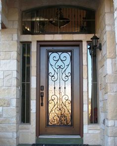 the front door is decorated with wrought iron