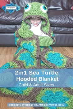 a child wrapped in a turtle blanket on the floor with text overlay that reads, 2in1 sea turtle hooded blanket child & adult sizes