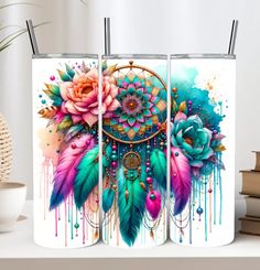 three colorful watercolor paintings with flowers and feathers on them, one has a dream catcher