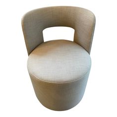 an upholstered chair with a curved back and seat cushion on the bottom half