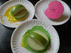 three paper plates with different colored food on them