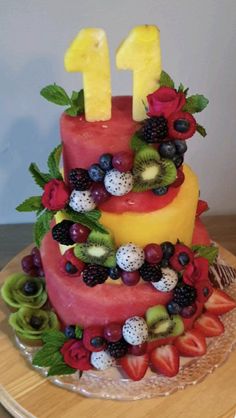 a cake with fruit on it and the number one made out of watermelon