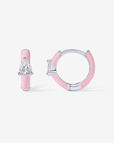 These colored enamel huggie earrings are the perfect accessory to elevate both day and evening looks. Whether you're going for trendy sophistication or a subtle hint of glam, these earrings have got you covered. Materials: 14K yellow or white gold plated. 925 sterling silver posts. AAAAA Cubic Zirconia. Blue, Pink, Purple or White Enamel. Measurements: Diameter: 10.8mm (.42"); Thickness: 2mm. Stone size: 3x4 mm. Dangle Necklaces, Toggle Bracelet, Pink Enamel, Huggie Earrings, Bracelet Collection, Everyday Jewelry, White Enamel, Pearl Ring, Huggies Earrings