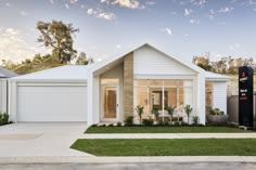 a white house sitting on top of a lush green field