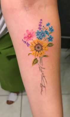 a woman's leg with flowers on it and the word love written in cursive writing