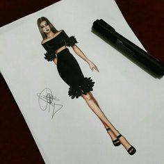 a drawing of a woman in a black dress next to a pen and paper on a table