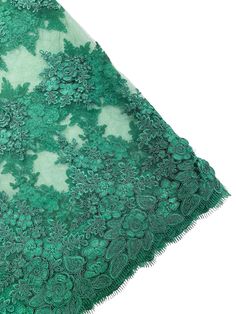 a green lace fabric with flowers on it