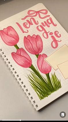 a notebook with some pink flowers on it