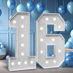 the number sixteen is surrounded by balloons and streamers in this blue room for a birthday party