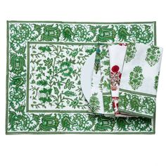 green and white placemats with matching napkins on each side, one has a red rose in the middle