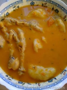 a bowl of soup with chicken wings in it