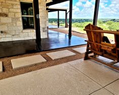 a wooden bench sitting on top of a stone floor next to a door and windows