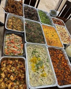 a table topped with lots of trays filled with food