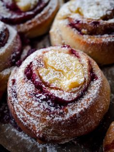 powdered sugar and jelly filled pastries on a table